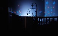 baby's black wooden crib with LED crib mobile